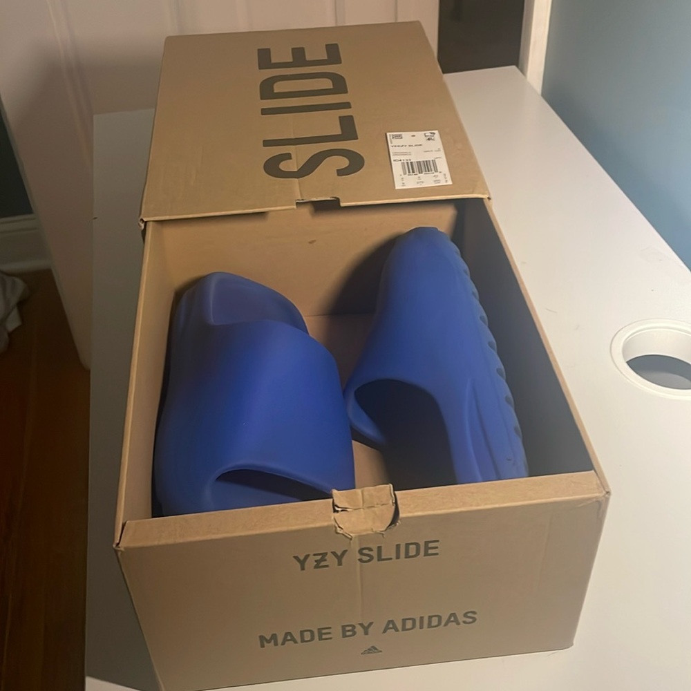 Size 9 Yeezy Slide Azure.   Worn condition, with original box.